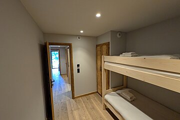 A bedroom with bunk beds and a doorway
