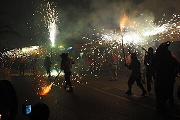 people carrying fireworks in the streets in mallorca