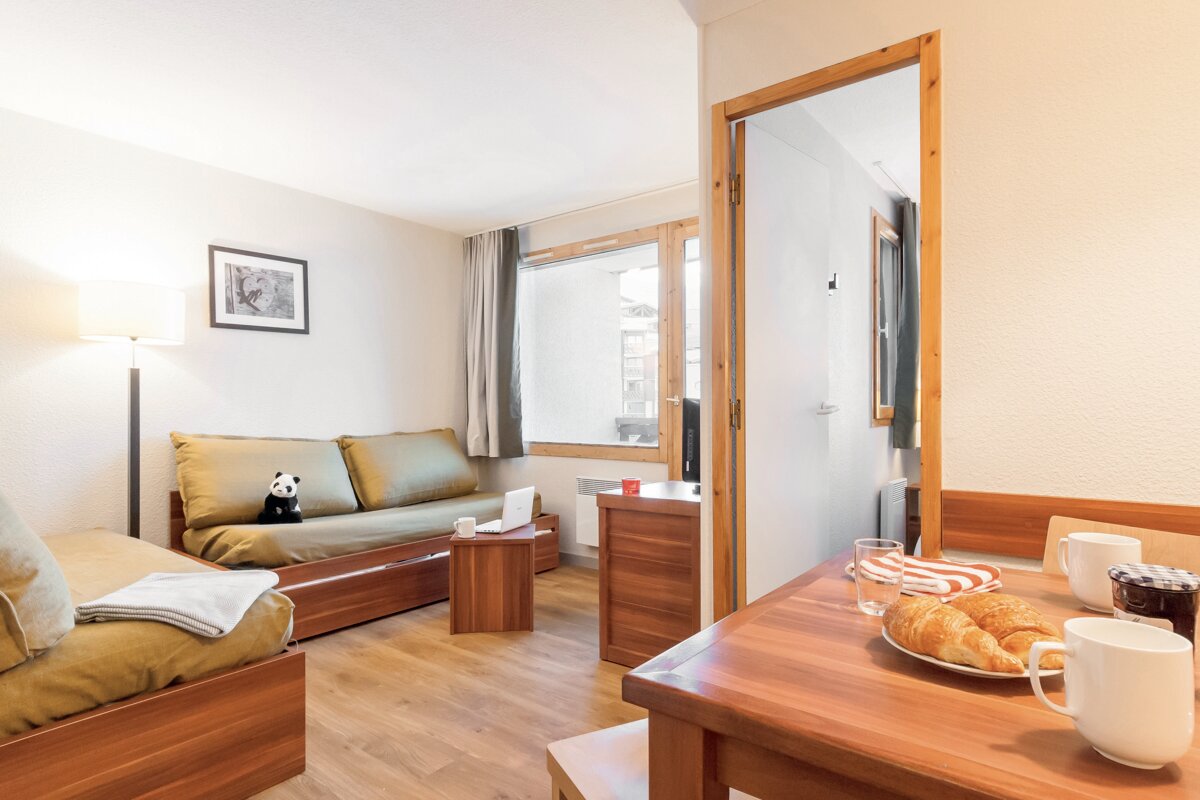 A living room with a couch and a table with croissants on it