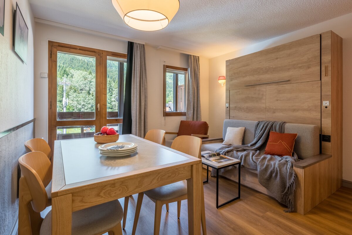 A living room with a table and chairs and a couch