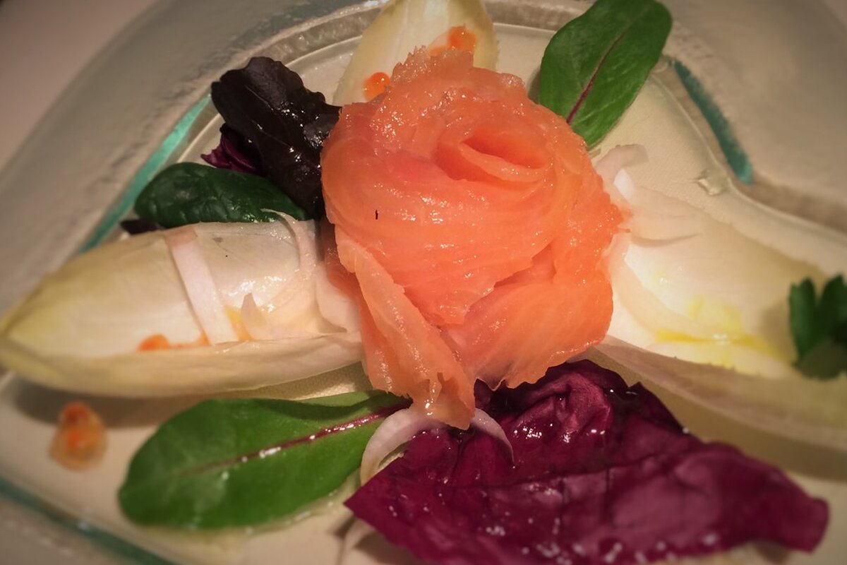A plate of food with a slice of smoked salmon on top