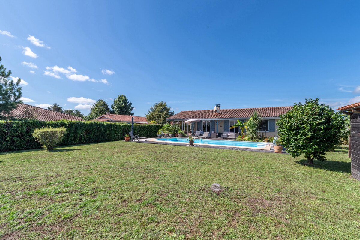 A house with a large swimming pool in the backyard