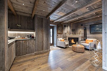 A living room with a fireplace and two chairs