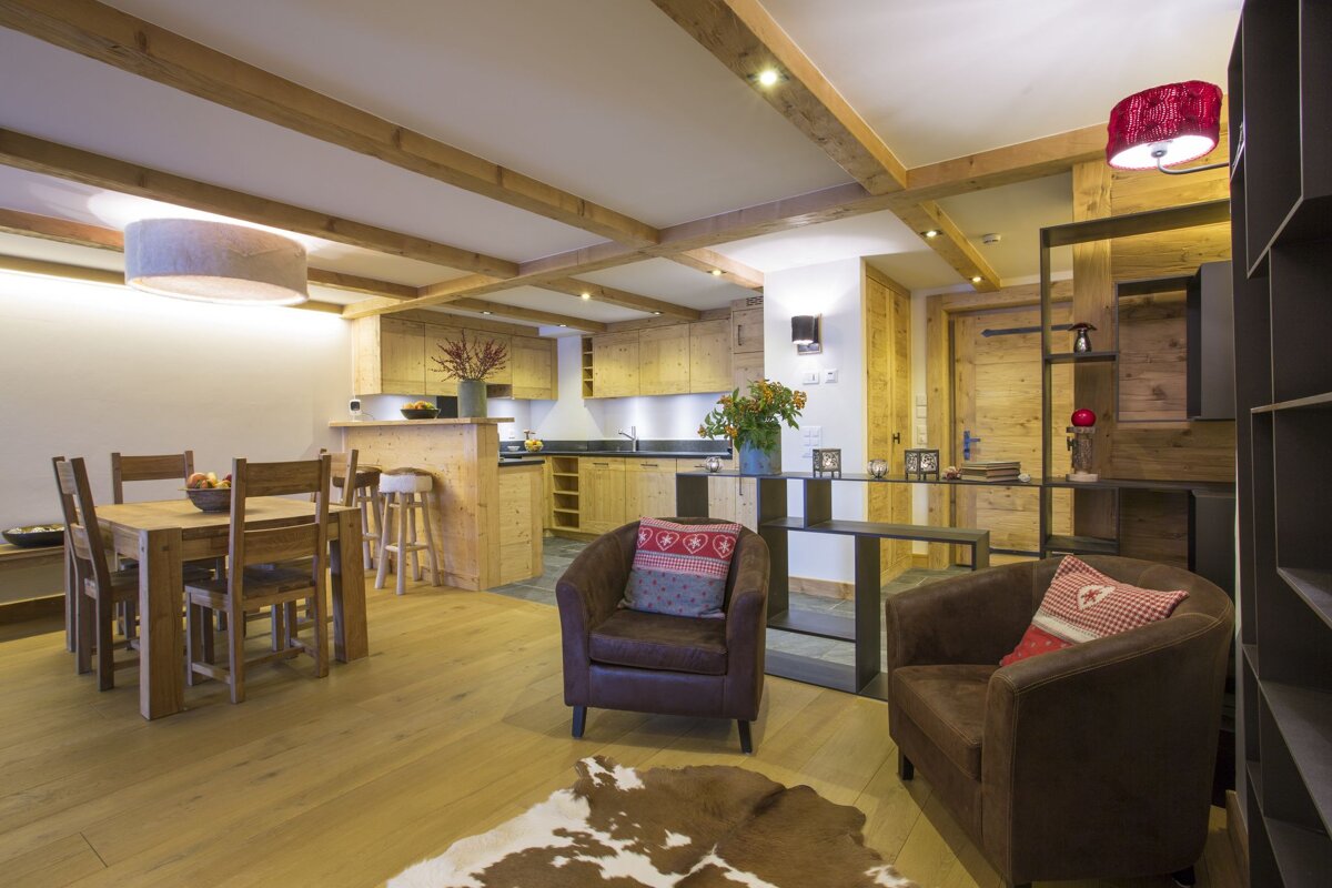 A living room with a dining table and chairs