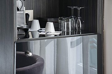 A shelf with cups and wine glasses on it