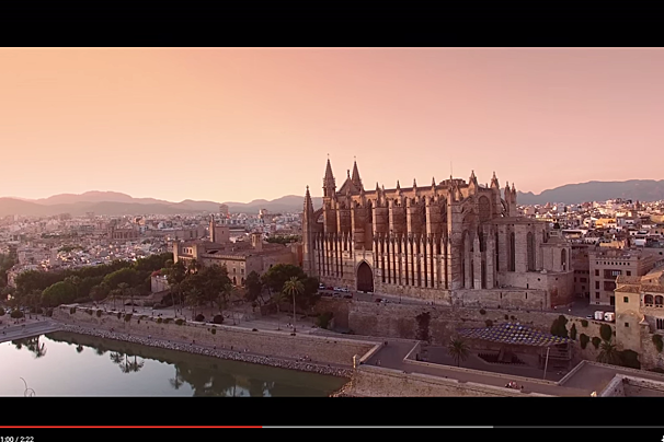An aerial view of a city with a large building in the foreground