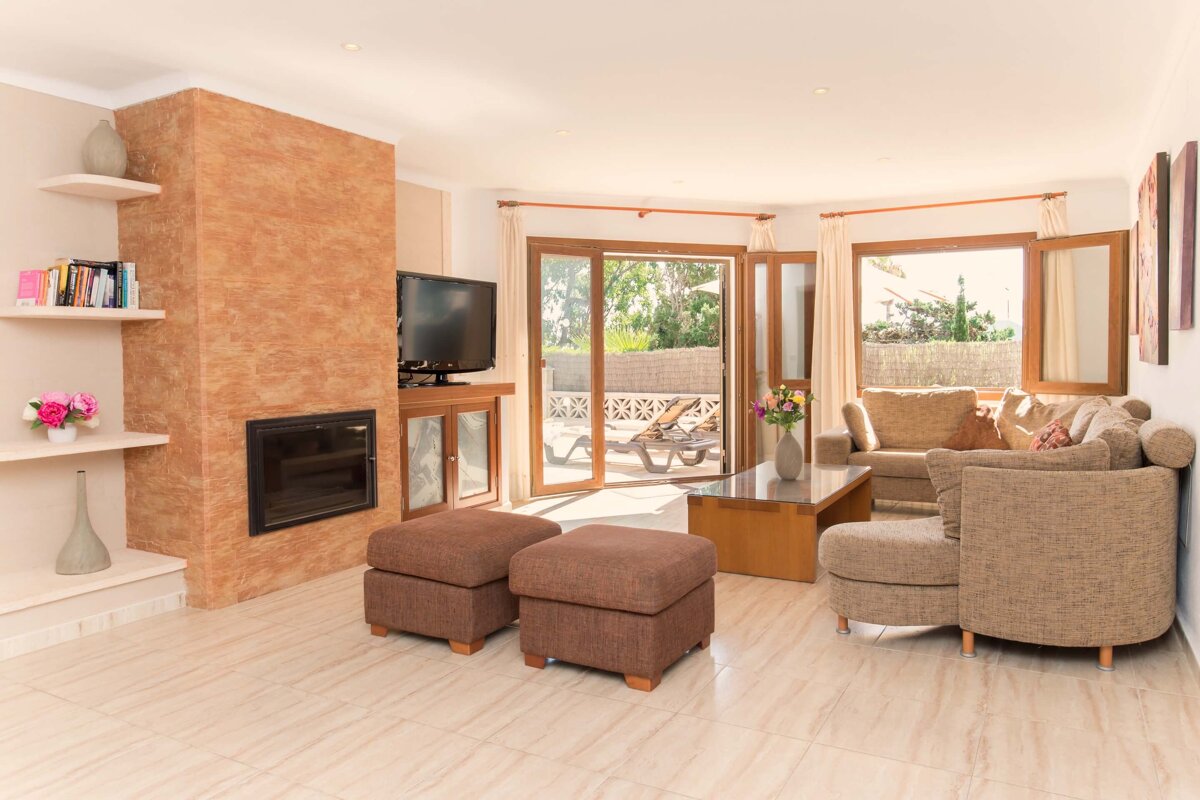 A living room with a fireplace and a flat screen tv