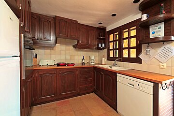 A kitchen with a sign on the wall that says