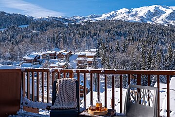 A balcony with a view of snow covered mountains
