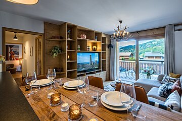 A living room with a sliding glass door and a flat screen tv
