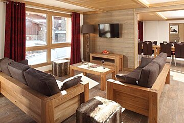 A living room with wooden furniture and a flat screen tv