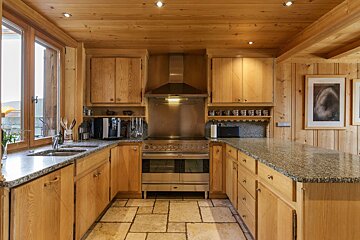 A kitchen with wooden cabinets and granite counter tops