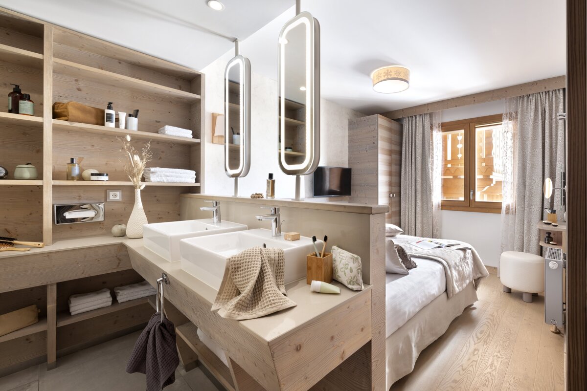 A bathroom with two sinks and two mirrors
