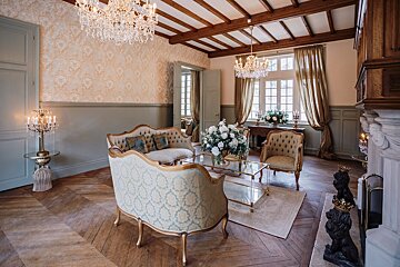 A living room with a couch and two chairs