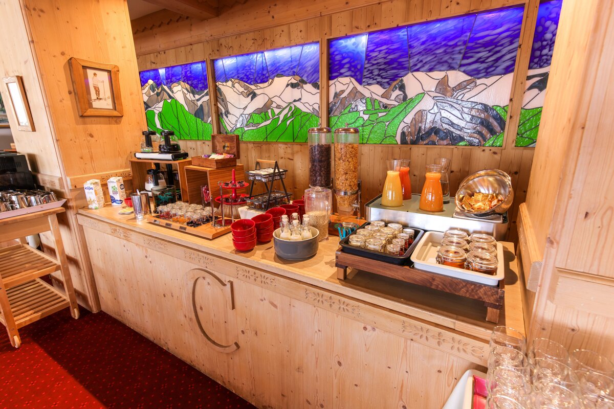 A buffet with a painting of mountains in the background