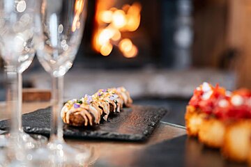 A plate of food with a fireplace in the background