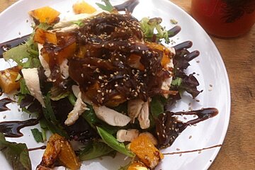 a white plate piled up high with salad