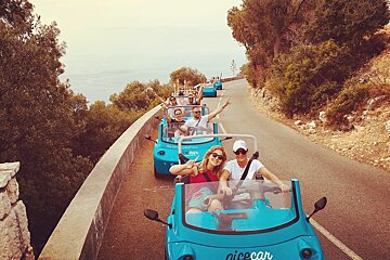 A group of people are riding in a nice car