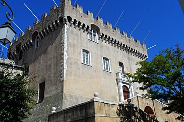 A very tall building with a balcony on the top of it