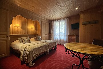 A hotel room with two beds and a table