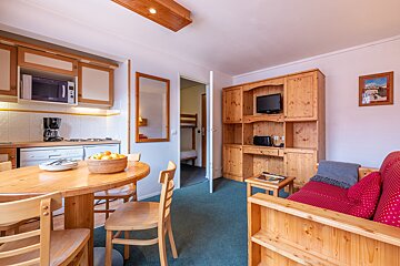 A living room with a couch a table and a microwave