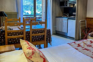 A bedroom with a polka dot table cloth and chairs