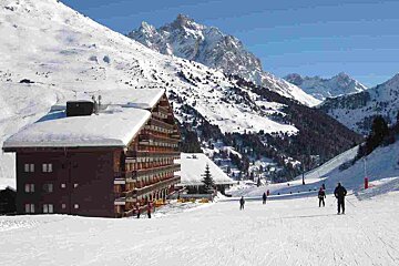 a large chalet hotel in mottaret in winter