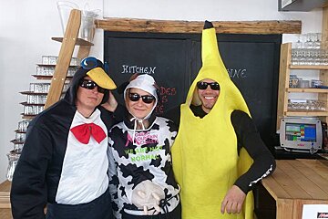three people in fancy dress in a restaurant