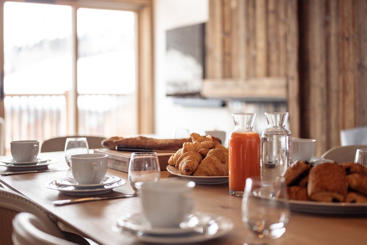 A table with plates of food and a bottle of orange juice