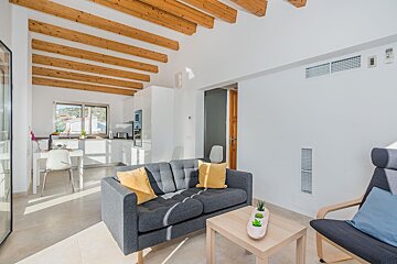 A living room with a grey couch and yellow pillows