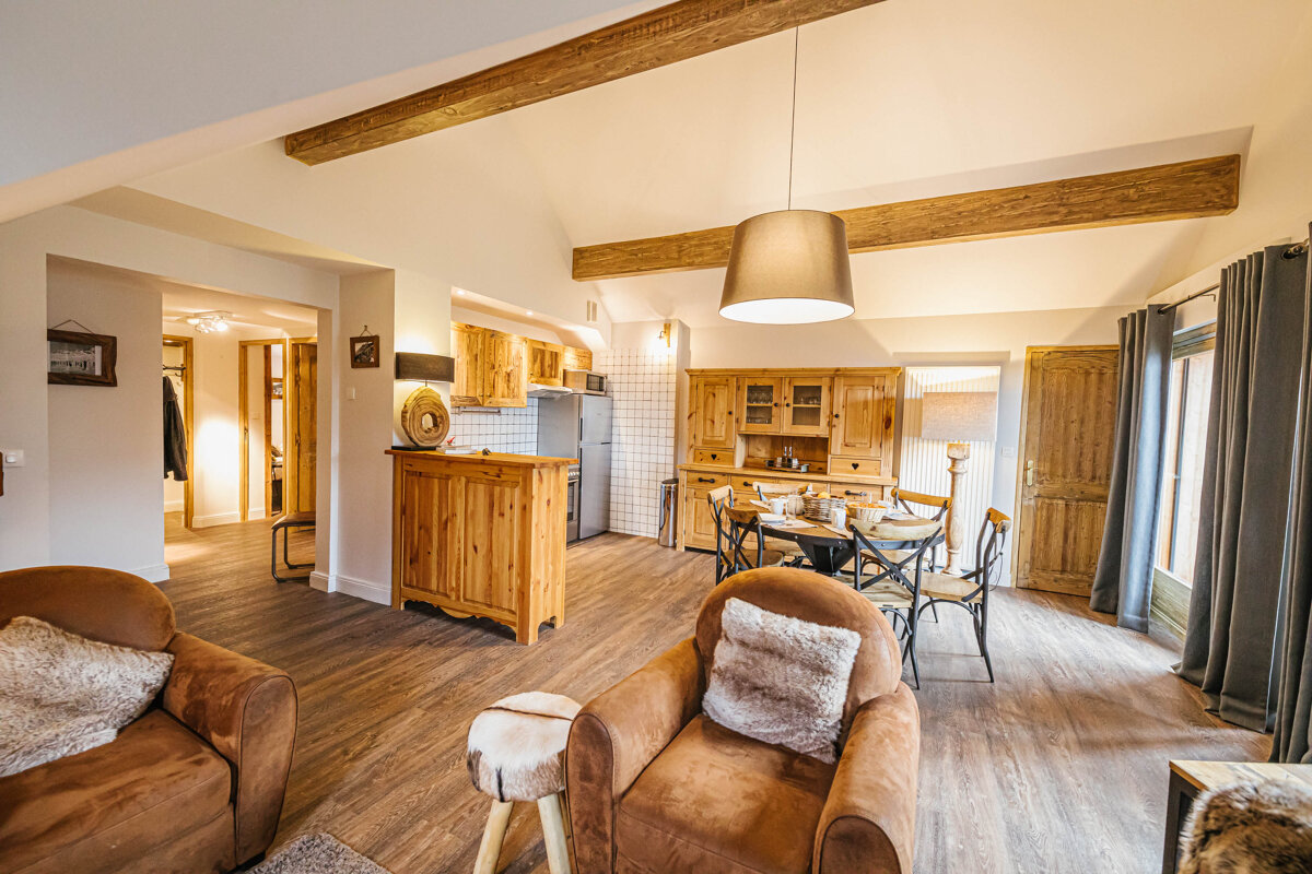 A living room with a dining table and chairs