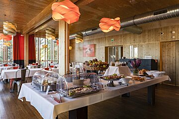 A buffet table with a basket of fruit on it