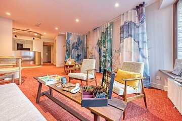 A living room with two chairs and a table with a board game on it