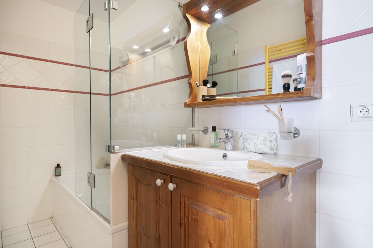 A bathroom with a sink a mirror and a bathtub