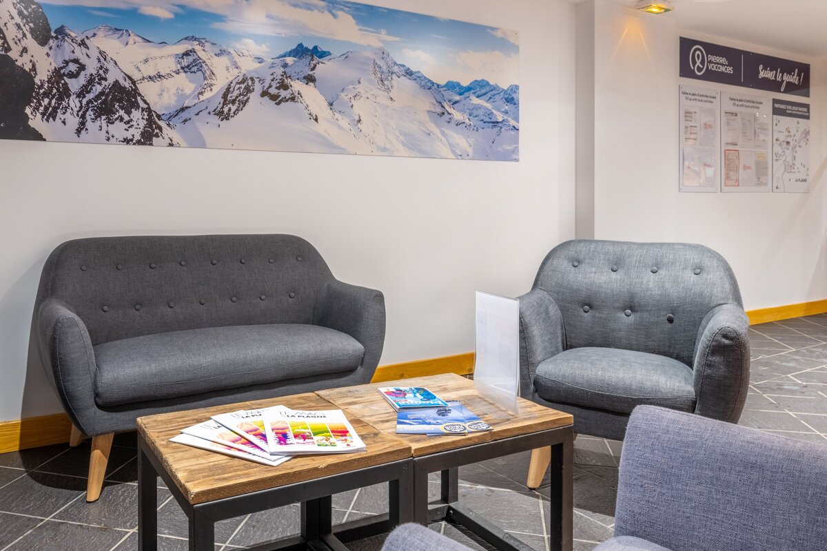 Two chairs and a couch in a room with a sign that says montagne