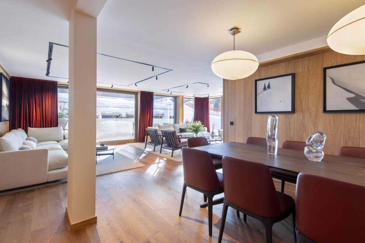 A living room with a dining table and chairs