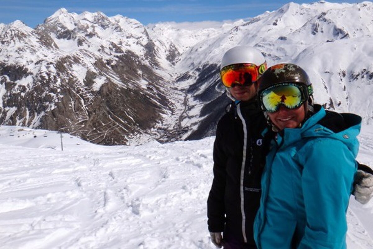 a Skier and a snowboarder smiling for the camera