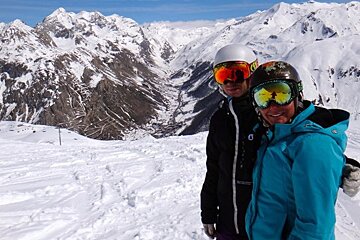 a Skier and a snowboarder smiling for the camera