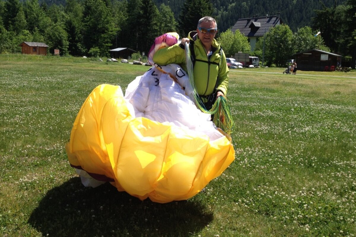 a man with a paragliding sail in chamonix