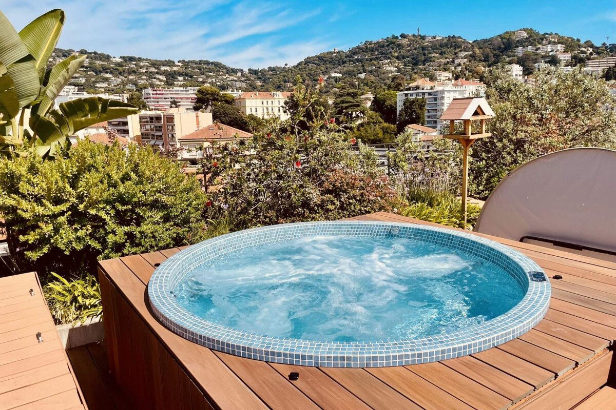 A hot tub with a view of a city in the background