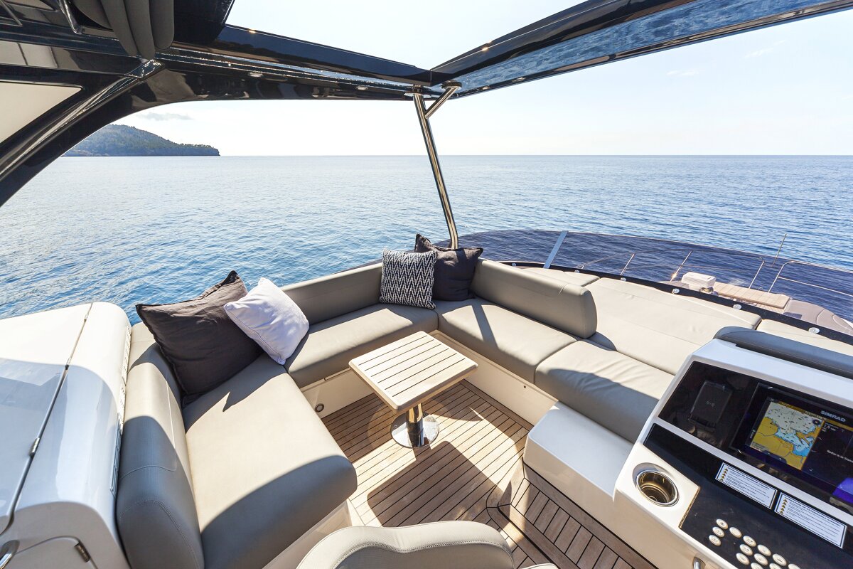 A boat with a couch and a table in the middle of the ocean