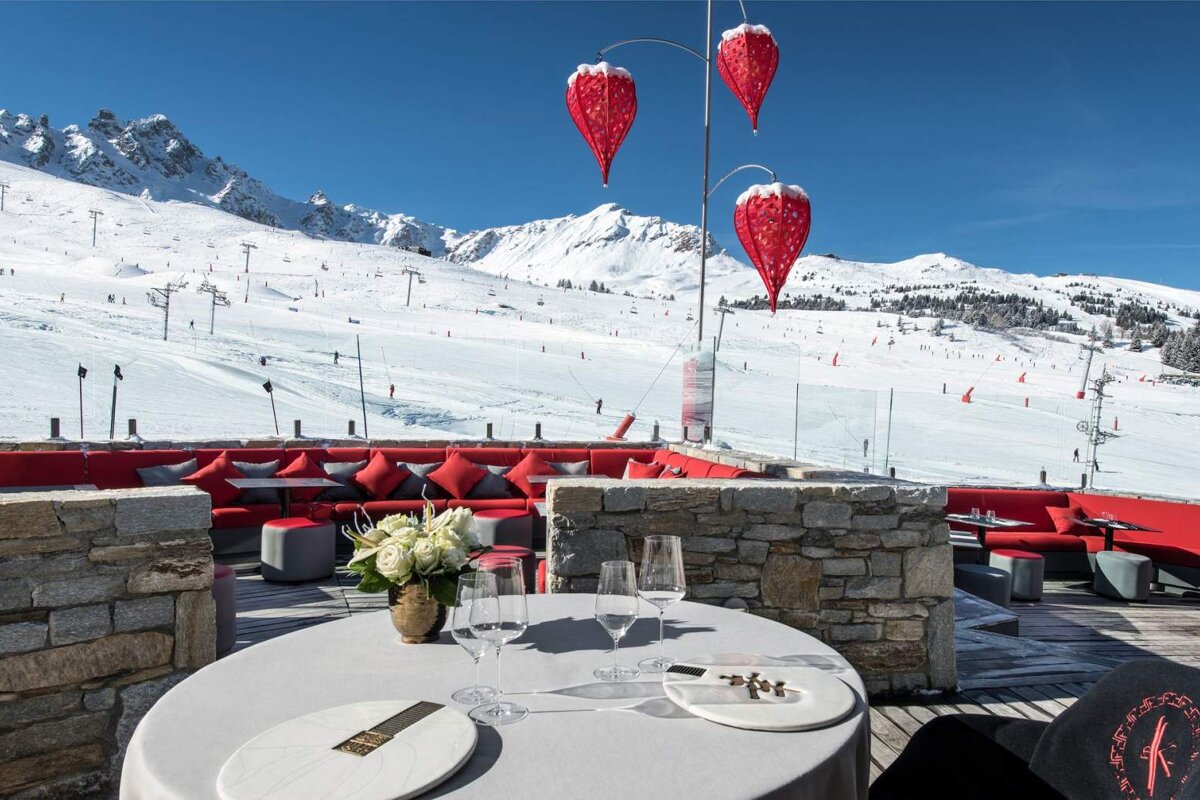 A table set for a meal with a mountain in the background