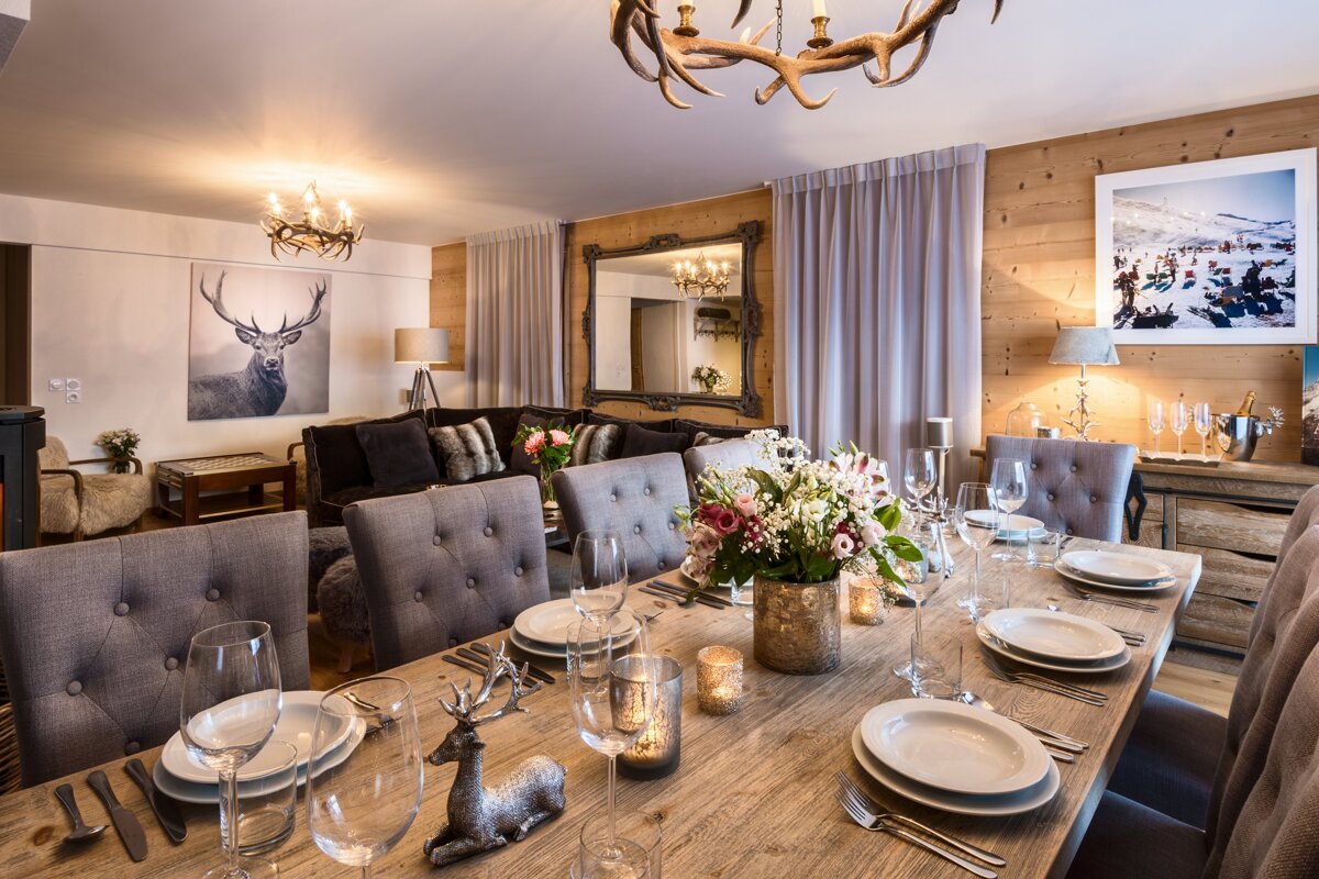 A dining room table with plates and glasses on it
