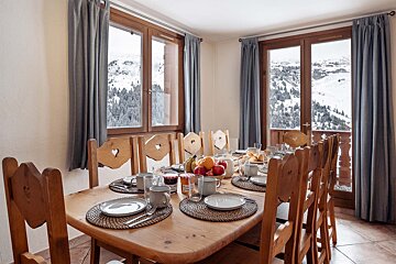 A dining room table with plates and cups on it