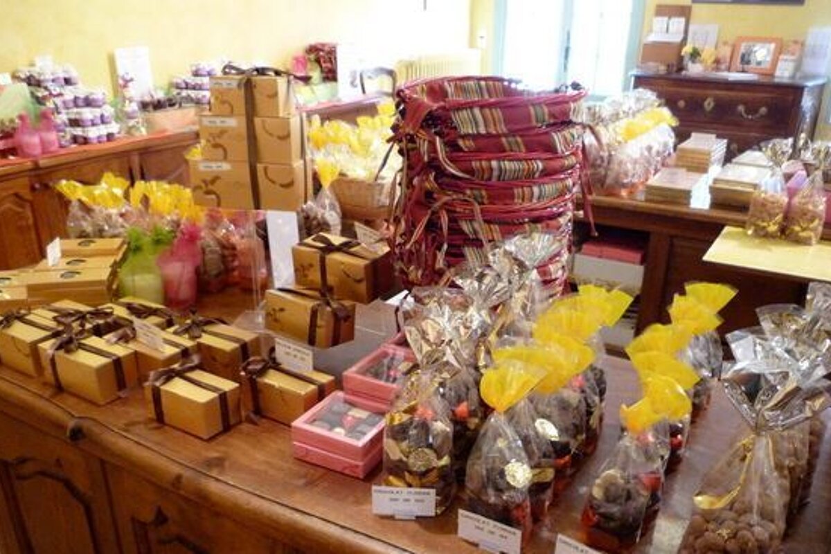 A table filled with boxes of chocolates and bags of nuts