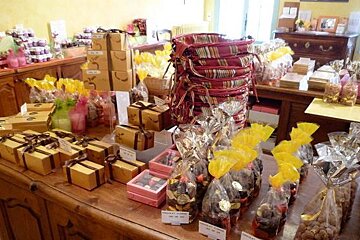 A table filled with boxes of chocolates and bags of nuts
