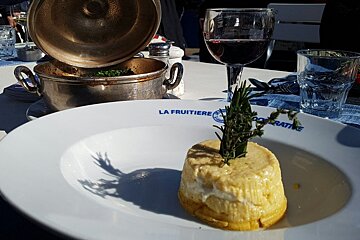a round plate with an upturned pie and rosemary poking out the top