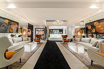 A living room with a couch and chairs and a chandelier