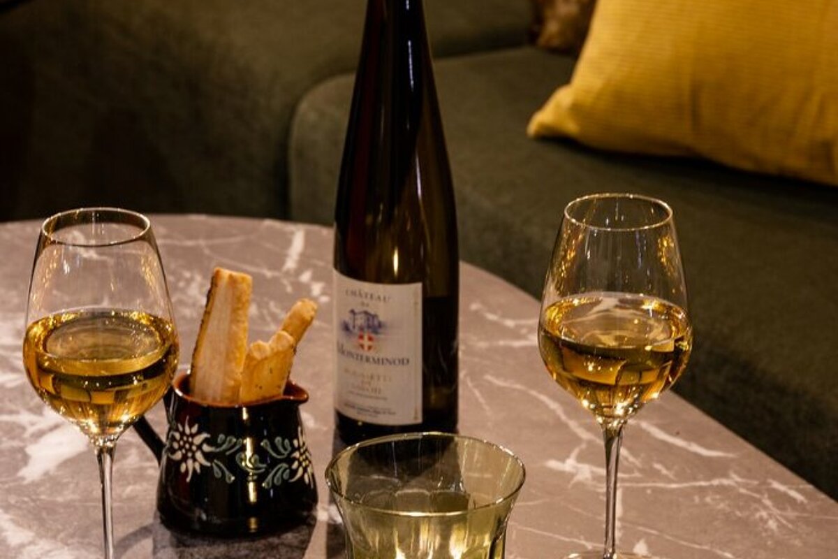 Two glasses of wine and a bottle of chateau on a table