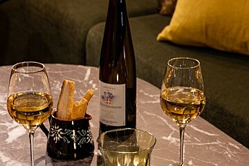 Two glasses of wine and a bottle of chateau on a table